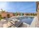 Relaxing pool area with lounge chairs and fire pit at 9705 Yellow Shadow Ave, Las Vegas, NV 89149