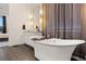 Elegant bathroom featuring a freestanding tub and dark wood flooring at 1121 Du Fort Hills Ct, Henderson, NV 89002