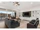 Living room with built-in shelving, large sectional sofa, and access to backyard pool at 1121 Du Fort Hills Ct, Henderson, NV 89002