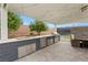 Outdoor kitchen with stainless steel appliances under covered patio at 1121 Du Fort Hills Ct, Henderson, NV 89002