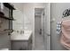 Modern bathroom with gray vanity, and view into hallway at 11885 Grassy Plain Ave, Las Vegas, NV 89138