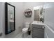 Small bathroom with gray vanity, toilet, and floating shelf at 11885 Grassy Plain Ave, Las Vegas, NV 89138