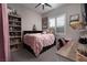 Bedroom with a bookcase, desk, and pink bedding at 11885 Grassy Plain Ave, Las Vegas, NV 89138