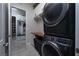 Modern laundry room with stacked washer and dryer, and a built-in counter at 11885 Grassy Plain Ave, Las Vegas, NV 89138