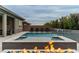 Inviting pool and spa with a fire pit and water feature at 11885 Grassy Plain Ave, Las Vegas, NV 89138