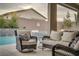 Relaxing patio area with wicker furniture near the pool at 11885 Grassy Plain Ave, Las Vegas, NV 89138