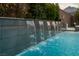 Close-up view of cascading water feature next to the pool at 11885 Grassy Plain Ave, Las Vegas, NV 89138