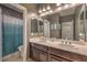 Well-lit bathroom featuring double sinks, a large mirror, and a shower-tub combination at 12259 Pacific Cruise Ave, Las Vegas, NV 89138