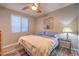 Cozy bedroom with hardwood floors, ample natural light, and a ceiling fan at 12259 Pacific Cruise Ave, Las Vegas, NV 89138