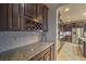 Stylish kitchen with granite countertops, stainless steel appliances, and custom wine rack at 12259 Pacific Cruise Ave, Las Vegas, NV 89138