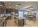 Modern kitchen with granite countertops, stainless steel appliances, and an adjacent dining area at 12259 Pacific Cruise Ave, Las Vegas, NV 89138