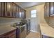 Laundry room with modern washer and dryer units, ample counter space, and storage cabinets at 12259 Pacific Cruise Ave, Las Vegas, NV 89138