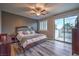 Spacious main bedroom with ensuite, ceiling fan, and sliding glass door leading to an outdoor terrace at 12259 Pacific Cruise Ave, Las Vegas, NV 89138