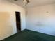 Spacious bedroom with green carpet and an ensuite bathroom at 1275 White Dr, Las Vegas, NV 89119