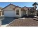 One-story house with a two-car garage and a landscaped front yard at 1275 White Dr, Las Vegas, NV 89119