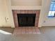 Simple fireplace with a light pink tile surround at 1275 White Dr, Las Vegas, NV 89119