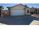 Two-car garage with a white door and a concrete driveway at 1275 White Dr, Las Vegas, NV 89119