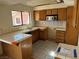 Kitchen with wood cabinets and patterned floor at 1275 White Dr, Las Vegas, NV 89119