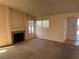 Living room with a fireplace and large windows at 1275 White Dr, Las Vegas, NV 89119