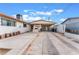 This long backyard features ample driveway space, a small garden, and an exterior fireplace at 1309 Jimmy Ave, Las Vegas, NV 89106