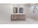 Bathroom showcasing double sink vanity, stylish mirrors and a glass enclosed walk-in shower at 1309 Jimmy Ave, Las Vegas, NV 89106