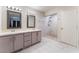 Modern bathroom with double sinks, marble-look tile flooring, and a glass-enclosed shower at 1309 Jimmy Ave, Las Vegas, NV 89106