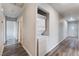 Hallway with laundry appliances, neutral walls and white doors leading to other areas of the home at 1309 Jimmy Ave, Las Vegas, NV 89106