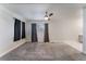 Bright living room with neutral walls, ceiling fan, large windows, and plush gray carpeting at 1309 Jimmy Ave, Las Vegas, NV 89106