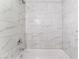 Updated shower-tub featuring a rain shower and white marble-like tiles at 1309 Jimmy Ave, Las Vegas, NV 89106