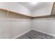 Spacious walk-in closet featuring carpet floors, white walls, and a wooden hanging rod at 1309 Jimmy Ave, Las Vegas, NV 89106