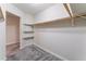 Walk-in closet with carpet, custom shelving, and a wood rod for hanging clothes at 1309 Jimmy Ave, Las Vegas, NV 89106