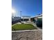 Serene backyard featuring a dining set under a pergola and manicured artificial turf at 1737 W Nelson Ave, North Las Vegas, NV 89032