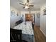 Light and bright eating area adjacent to the kitchen featuring a ceiling fan and access to kitchen at 1737 W Nelson Ave, North Las Vegas, NV 89032