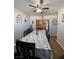 Light and bright eating area adjacent to the kitchen featuring a ceiling fan and access to kitchen at 1737 W Nelson Ave, North Las Vegas, NV 89032