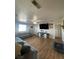 Comfortable living room featuring wood floors, a large TV, and a gray sofa at 1737 W Nelson Ave, North Las Vegas, NV 89032