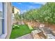 Small grassy backyard with patio and seating at 1903 Sundown Canyon Dr, Henderson, NV 89014