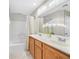 Double vanity bathroom with wood cabinets and a shower/tub combo at 1903 Sundown Canyon Dr, Henderson, NV 89014