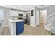 Updated kitchen with white cabinets and a blue island at 1903 Sundown Canyon Dr, Henderson, NV 89014