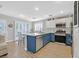 Modern kitchen with blue cabinets and stainless steel appliances at 1903 Sundown Canyon Dr, Henderson, NV 89014