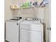 Bright laundry room with washer, dryer, and shelving at 1903 Sundown Canyon Dr, Henderson, NV 89014