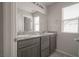 Bathroom featuring a double vanity with granite countertops and a large mirror at 2240 Sky Island Dr, Henderson, NV 89002