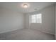 Bedroom with plush gray carpeting, neutral walls, and a window with natural light at 2240 Sky Island Dr, Henderson, NV 89002