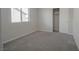 Bedroom with plush gray carpeting, closet and a window with natural light at 2240 Sky Island Dr, Henderson, NV 89002