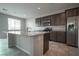 Kitchen features gray cabinets, stainless steel appliances, and granite countertops at 2240 Sky Island Dr, Henderson, NV 89002