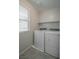 Laundry room features new white washer and dryer, neutral walls, and tiled floor at 2240 Sky Island Dr, Henderson, NV 89002