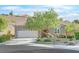 Front view of house with attached garage and mature tree at 2525 Hamonah Dr, Henderson, NV 89044