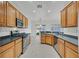 Spacious kitchen featuring wood cabinetry, granite countertops, and stainless steel appliances at 2525 Hamonah Dr, Henderson, NV 89044