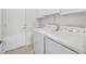 Bright laundry room with washer, dryer, and built-in cabinets at 2525 Hamonah Dr, Henderson, NV 89044