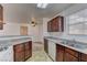 Galley kitchen features granite counter tops, laminate floors and view into dining area at 2801 N Rainbow Blvd # 255, Las Vegas, NV 89108