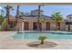 Community pool surrounded by palm trees and well-maintained landscaping, perfect for relaxation and social gatherings at 2801 N Rainbow Blvd # 255, Las Vegas, NV 89108